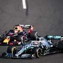 HUNGARORING, HUNGARY - AUGUST 04: Lewis Hamilton, Mercedes AMG F1 W10, passes Max Verstappen, Red Bull Racing RB15, for the lead during the Hungarian GP at Hungaroring on August 04, 2019 in Hungaroring, Hungary. (Photo by Sam Bloxham / LAT Images)