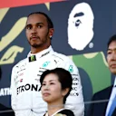SUZUKA, JAPAN - OCTOBER 13: Third placed Lewis Hamilton of Great Britain and Mercedes GP looks on, on the podium during the F1 Grand Prix of Japan at Suzuka Circuit on October 13, 2019 in Suzuka, Japan. (Photo by Clive Mason/Getty Images)