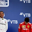 SOCHI, RUSSIA - SEPTEMBER 29: Race winner Lewis Hamilton of Great Britain and Mercedes GP celebrates as third placed Charles Leclerc of Monaco and Ferrari looks dejected on the podium during the F1 Grand Prix of Russia at Sochi Autodrom on September 29, 2019 in Sochi, Russia. (Photo by Clive Mason/Getty Images)