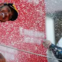 CIRCUIT DE BARCELONA-CATALUNYA, SPAIN - MAY 12: Lewis Hamilton, Mercedes AMG F1, 1st position, is blasted with Champagne by Valtteri Bottas, Mercedes AMG F1, 2nd position, on the podium during the Spanish GP at Circuit de Barcelona-Catalunya on May 12, 2019 in Circuit de Barcelona-Catalunya, Spain. (Photo by Andy Hone / LAT Images)