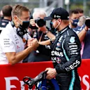 NORTHAMPTON, ENGLAND - AUGUST 08: Pole position qualifier Valtteri Bottas of Finland and Mercedes GP celebrates with a team member in parc ferme during qualifying for the F1 70th Anniversary Grand Prix at Silverstone on August 08, 2020 in Northampton, England. (Photo by Andrew Boyers/Pool via Getty Images)