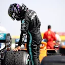 NORTHAMPTON, ENGLAND - AUGUST 09: Second placed Lewis Hamilton of Great Britain and Mercedes GP checks the wear on his tyres in parc ferme during the F1 70th Anniversary Grand Prix at Silverstone on August 09, 2020 in Northampton, England. (Photo by Bryn Lennon/Getty Images)
