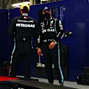 ABU DHABI, UNITED ARAB EMIRATES - DECEMBER 12: Second place qualifier Valtteri Bottas of Finland and Mercedes GP and third place qualifier Lewis Hamilton of Great Britain and Mercedes GP talk as they are weighed in parc ferme during qualifying ahead of the F1 Grand Prix of Abu Dhabi at Yas Marina Circuit on December 12, 2020 in Abu Dhabi, United Arab Emirates. (Photo by Dan Istitene - Formula 1/Formula 1 via Getty Images)