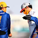 ABU DHABI, UNITED ARAB EMIRATES - DECEMBER 13: Carlos Sainz of Spain and McLaren F1 talks with teammate Lando Norris of Great Britain and McLaren F1 on the grid prior to the F1 Grand Prix of Abu Dhabi at Yas Marina Circuit on December 13, 2020 in Abu Dhabi, United Arab Emirates. (Photo by Dan Istitene - Formula 1/Formula 1 via Getty Images)