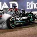 ABU DHABI, UNITED ARAB EMIRATES - DECEMBER 13: Third placed Lewis Hamilton of Great Britain driving the (44) Mercedes AMG Petronas F1 Team Mercedes W11 does donuts after the F1 Grand Prix of Abu Dhabi at Yas Marina Circuit on December 13, 2020 in Abu Dhabi, United Arab Emirates. (Photo by Clive Mason - Formula 1/Formula 1 via Getty Images)