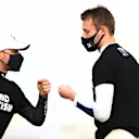 ABU DHABI, UNITED ARAB EMIRATES - DECEMBER 13: Valtteri Bottas of Finland and Mercedes GP and Daniil Kvyat of Russia and Scuderia AlphaTauri fist bump as they stand on the grid prior to the F1 Grand Prix of Abu Dhabi at Yas Marina Circuit on December 13, 2020 in Abu Dhabi, United Arab Emirates. (Photo by Dan Istitene - Formula 1/Formula 1 via Getty Images)