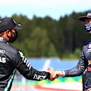 SPIELBERG, AUSTRIA - JULY 04: Second place qualifier Lewis Hamilton of Great Britain and Mercedes GP and third place qualifier Max Verstappen of Netherlands and Red Bull Racing shake hands in parc ferme during qualifying for the Formula One Grand Prix of Austria at Red Bull Ring on July 04, 2020 in Spielberg, Austria. (Photo by Dan Istitene - Formula 1/Formula 1 via Getty Images)