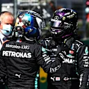SPIELBERG, AUSTRIA - JULY 04: Pole position qualifier Valtteri Bottas of Finland and Mercedes GP and second place qualifier Lewis Hamilton of Great Britain and Mercedes GP shake hands in parc ferin parc fermeduring qualifying for the Formula One Grand Prix of Austria at Red Bull Ring on July 04, 2020 in Spielberg, Austria. (Photo by Dan Istitene - Formula 1/Formula 1 via Getty Images)