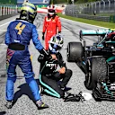 SPIELBERG, AUSTRIA - JULY 05: Race winner Valtteri Bottas of Finland driving the (77) Mercedes AMG Petronas F1 Team Mercedes W11  interacts with third placed Lando Norris of Great Britain and McLaren F1 during the Formula One Grand Prix of Austria at Red Bull Ring on July 05, 2020 in Spielberg, Austria. (Photo by Mark Thompson/Getty Images)