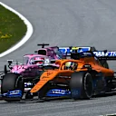SPIELBERG, AUSTRIA - JULY 05: Lando Norris of Great Britain driving the (4) McLaren F1 Team MCL35 Renault and Sergio Perez of Mexico driving the (11) Racing Point RP20 Mercedes battle for position during the Formula One Grand Prix of Austria at Red Bull Ring on July 05, 2020 in Spielberg, Austria. (Photo by Clive Mason - Formula 1/Formula 1 via Getty Images)