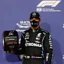 BAHRAIN, BAHRAIN - NOVEMBER 28: Pole position qualifier Lewis Hamilton of Great Britain and Mercedes GP poses with the pole position award in parc ferme during qualifying ahead of the F1 Grand Prix of Bahrain at Bahrain International Circuit on November 28, 2020 in Bahrain, Bahrain. (Photo by Hamad Mohammed - Pool/Getty Images)