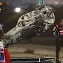 BAHRAIN, BAHRAIN - NOVEMBER 29: Track marshals clear the debris following the crash of Romain Grosjean of France and Haas F1 during the F1 Grand Prix of Bahrain at Bahrain International Circuit on November 29, 2020 in Bahrain, Bahrain. (Photo by Tolga Bozoglu - Pool/Getty Images)