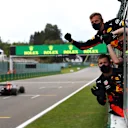 SPA, BELGIUM - AUGUST 30: Red Bull Racing team members celebrate on the pit wall as Max Verstappen of the Netherlands driving the (33) Aston Martin Red Bull Racing RB16 crosses the line to finish third during the F1 Grand Prix of Belgium at Circuit de Spa-Francorchamps on August 30, 2020 in Spa, Belgium. (Photo by Mark Thompson/Getty Images)