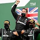 SPA, BELGIUM - AUGUST 30: Race winner Lewis Hamilton of Great Britain and Mercedes GP, second placed Valtteri Bottas of Finland and Mercedes GP and front end mechanic at Mercedes GP Sam Bradley celebrate on the podium during the F1 Grand Prix of Belgium at Circuit de Spa-Francorchamps on August 30, 2020 in Spa, Belgium. (Photo by Clive Mason - Formula 1/Formula 1 via Getty Images)