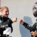 IMOLA, ITALY - OCTOBER 31: Pole position qualifier Valtteri Bottas of Finland and Mercedes GP bumps fists with second place qualifier Lewis Hamilton of Great Britain and Mercedes GP in parc ferme in parc ferme during qualifying ahead of the F1 Grand Prix of Emilia Romagna at Autodromo Enzo e Dino Ferrari on October 31, 2020 in Imola, Italy. (Photo by Luca Bruno - Pool/Getty Images)