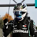 IMOLA, ITALY - OCTOBER 31: Pole position qualifier Valtteri Bottas of Finland and Mercedes GP climbs from his car in parc ferme during qualifying ahead of the F1 Grand Prix of Emilia Romagna at Autodromo Enzo e Dino Ferrari on October 31, 2020 in Imola, Italy. (Photo by Luca Bruno - Pool/Getty Images)