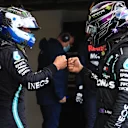 NUERBURG, GERMANY - OCTOBER 10: Second placed qualifier Lewis Hamilton of Great Britain and Mercedes GP and pole position qualifier Valtteri Bottas of Finland and Mercedes GP embrace in parc ferme during qualifying ahead of the F1 Eifel Grand Prix at Nuerburgring on October 10, 2020 in Nuerburg, Germany. (Photo by Wolfgang Rattay - Pool/Getty Images)