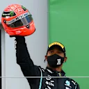 NUERBURG, GERMANY - OCTOBER 11: Race winner Lewis Hamilton of Great Britain and Mercedes GP celebrates after being presented with a helmet of Michael Schumacher for matching his record of 91 race wins during the F1 Eifel Grand Prix at Nuerburgring on October 11, 2020 in Nuerburg, Germany. (Photo by Clive Mason - Formula 1/Formula 1 via Getty Images)