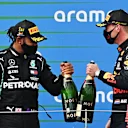 NUERBURG, GERMANY - OCTOBER 11: Race winner Lewis Hamilton of Great Britain and Mercedes GP and second placed Max Verstappen of Netherlands and Red Bull Racing celebrate on the podium during the F1 Eifel Grand Prix at Nuerburgring on October 11, 2020 in Nuerburg, Germany. (Photo by Ina Fassbender - Pool/Getty Images)