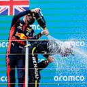 NUERBURG, GERMANY - OCTOBER 11: Race winner Lewis Hamilton of Great Britain and Mercedes GP and second placed Max Verstappen of Netherlands and Red Bull Racing celebrate on the podium during the F1 Eifel Grand Prix at Nuerburgring on October 11, 2020 in Nuerburg, Germany. (Photo by Ronald Wittek - Pool/Getty Images)