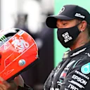 NUERBURG, GERMANY - OCTOBER 11: Race winner Lewis Hamilton of Great Britain and Mercedes GP celebrates after being presented with a helmet of Michael Schumacher for matching his record of 91 race wins during the F1 Eifel Grand Prix at Nuerburgring on October 11, 2020 in Nuerburg, Germany. (Photo by Dan Istitene - Formula 1/Formula 1 via Getty Images)