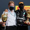 NORTHAMPTON, ENGLAND - AUGUST 02: Race winner Lewis Hamilton of Great Britain and Mercedes GP celebrates with a team member on the podium during the F1 Grand Prix of Great Britain at Silverstone on August 02, 2020 in Northampton, England. (Photo by Frank Augstein/Pool via Getty Images)