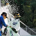 MONZA, ITALY - SEPTEMBER 06: Race winner Pierre Gasly of France and Scuderia AlphaTauri and second placed Carlos Sainz of Spain and McLaren F1 celebrate on the podium during the F1 Grand Prix of Italy at Autodromo di Monza on September 06, 2020 in Monza, Italy. (Photo by Luca Bruno - Pool/Getty Images)