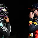 PORTIMAO, PORTUGAL - OCTOBER 24: Pole position qualifier Lewis Hamilton of Great Britain and Mercedes GP speaks with third placed Max Verstappen of Netherlands and Red Bull Racing in parc ferme during qualifying ahead of the F1 Grand Prix of Portugal at Autodromo Internacional do Algarve on October 24, 2020 in Portimao, Portugal. (Photo by Jose Sena Goulao - Pool/Getty Images)