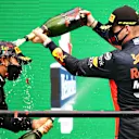 PORTIMAO, PORTUGAL - OCTOBER 25: Race winner Lewis Hamilton of Great Britain and Mercedes GP celebrates his record breaking 92nd race win on the podium with third placed Max Verstappen of Netherlands and Red Bull Racing during the F1 Grand Prix of Portugal at Autodromo Internacional do Algarve on October 25, 2020 in Portimao, Portugal. (Photo by Bryn Lennon - Formula 1/Formula 1 via Getty Images)