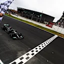 PORTIMAO, PORTUGAL - OCTOBER 25: Race winner Lewis Hamilton of Great Britain driving the (44) Mercedes AMG Petronas F1 Team Mercedes W11 takes the chequered flag for his record breaking 92nd race win during the F1 Grand Prix of Portugal at Autodromo Internacional do Algarve on October 25, 2020 in Portimao, Portugal. (Photo by Mario Renzi - Formula 1/Formula 1 via Getty Images)