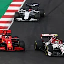 PORTIMAO, PORTUGAL - OCTOBER 25: Sebastian Vettel of Germany driving the (5) Scuderia Ferrari SF1000 and Antonio Giovinazzi of Italy driving the (99) Alfa Romeo Racing C39 Ferrari battle for position on track during the F1 Grand Prix of Portugal at Autodromo Internacional do Algarve on October 25, 2020 in Portimao, Portugal. (Photo by Joe Portlock/Getty Images)