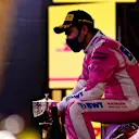 BAHRAIN, BAHRAIN - DECEMBER 06: Race winner Sergio Perez of Mexico and Racing Point celebrates his maiden F1 victory on the podium during the F1 Grand Prix of Sakhir at Bahrain International Circuit on December 06, 2020 in Bahrain, Bahrain. (Photo by Mario Renzi - Formula 1/Formula 1 via Getty Images)