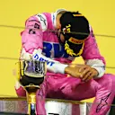 BAHRAIN, BAHRAIN - DECEMBER 06: Race winner Sergio Perez of Mexico and Racing Point celebrates his maiden F1 victory on the podium during the F1 Grand Prix of Sakhir at Bahrain International Circuit on December 06, 2020 in Bahrain, Bahrain. (Photo by Clive Mason - Formula 1/Formula 1 via Getty Images)
