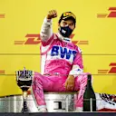 BAHRAIN, BAHRAIN - DECEMBER 06: Race winner Sergio Perez of Mexico and Racing Point celebrates his maiden F1 victory on the podium during the F1 Grand Prix of Sakhir at Bahrain International Circuit on December 06, 2020 in Bahrain, Bahrain. (Photo by Bryn Lennon/Getty Images)
