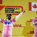 BAHRAIN, BAHRAIN - DECEMBER 06: Race winner Sergio Perez of Mexico and Racing Point celebrates his maiden F1 victory on the podium during the F1 Grand Prix of Sakhir at Bahrain International Circuit on December 06, 2020 in Bahrain, Bahrain. (Photo by Bryn Lennon/Getty Images)