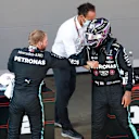 BARCELONA, SPAIN - AUGUST 15: Second placed qualifier Valtteri Bottas of Finland and Mercedes GP and Pole position qualifier Lewis Hamilton of Great Britain and Mercedes GP celebrate in parc ferme during qualifying for the F1 Grand Prix of Spain at Circuit de Barcelona-Catalunya on August 15, 2020 in Barcelona, Spain. (Photo by Alejandro Garcia/Pool via Getty Images)