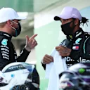BARCELONA, SPAIN - AUGUST 15: Pole position qualifier Lewis Hamilton of Great Britain and Mercedes GP talks to second placed qualifier Valtteri Bottas of Finland and Mercedes GP during qualifying for the F1 Grand Prix of Spain at Circuit de Barcelona-Catalunya on August 15, 2020 in Barcelona, Spain. (Photo by Albert Gea/Pool via Getty Images)