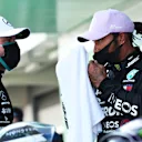 BARCELONA, SPAIN - AUGUST 15: Pole position qualifier Lewis Hamilton of Great Britain and Mercedes GP talks to second placed qualifier Valtteri Bottas of Finland and Mercedes GP during qualifying for the F1 Grand Prix of Spain at Circuit de Barcelona-Catalunya on August 15, 2020 in Barcelona, Spain. (Photo by Albert Gea/Pool via Getty Images)