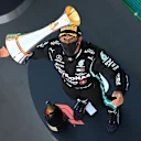 BARCELONA, SPAIN - AUGUST 16: Race winner Lewis Hamilton of Great Britain and Mercedes GP celebrates on the podium by throwing his trophy in the air during the F1 Grand Prix of Spain at Circuit de Barcelona-Catalunya on August 16, 2020 in Barcelona, Spain. (Photo by Clive Mason - Formula 1/Formula 1 via Getty Images)