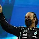 ABU DHABI, UNITED ARAB EMIRATES - DECEMBER 12: Second placed Lewis Hamilton of Great Britain and Mercedes GP waves from the podium during the F1 Grand Prix of Abu Dhabi at Yas Marina Circuit on December 12, 2021 in Abu Dhabi, United Arab Emirates. (Photo by Bryn Lennon/Getty Images)