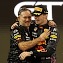 ABU DHABI, UNITED ARAB EMIRATES - DECEMBER 12: Race winner and 2021 F1 World Drivers Champion Max Verstappen of Netherlands and Red Bull Racing celebrates with Red Bull Racing Team Principal Christian Horner on the podium during the F1 Grand Prix of Abu Dhabi at Yas Marina Circuit on December 12, 2021 in Abu Dhabi, United Arab Emirates. (Photo by Lars Baron/Getty Images)