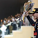 ABU DHABI, UNITED ARAB EMIRATES - DECEMBER 12: Race winner and 2021 F1 World Drivers Champion Max Verstappen of Netherlands and Red Bull Racing celebrates on the podium during the F1 Grand Prix of Abu Dhabi at Yas Marina Circuit on December 12, 2021 in Abu Dhabi, United Arab Emirates. (Photo by Dan Istitene - Formula 1/Formula 1 via Getty Images)