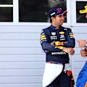 SPIELBERG, AUSTRIA - JULY 03: Second place qualifier Lando Norris of Great Britain and McLaren F1 and third place qualifier Sergio Perez of Mexico and Red Bull Racing talk in parc ferme during qualifying ahead of the F1 Grand Prix of Austria at Red Bull Ring on July 03, 2021 in Spielberg, Austria. (Photo by Dan Istitene - Formula 1/Formula 1 via Getty Images)