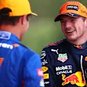 SPIELBERG, AUSTRIA - JULY 03: Pole position qualifier Max Verstappen of Netherlands and Red Bull Racing and second place qualifier Lando Norris of Great Britain and McLaren F1 talk in parc ferme during qualifying ahead of the F1 Grand Prix of Austria at Red Bull Ring on July 03, 2021 in Spielberg, Austria. (Photo by Dan Istitene - Formula 1/Formula 1 via Getty Images)