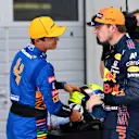 SPIELBERG, AUSTRIA - JULY 03: Pole position qualifier Max Verstappen of Netherlands and Red Bull Racing and second place qualifier Lando Norris of Great Britain and McLaren F1 talk in parc ferme during qualifying ahead of the F1 Grand Prix of Austria at Red Bull Ring on July 03, 2021 in Spielberg, Austria. (Photo by Christian Bruna - Pool/Getty Images)