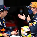 SPIELBERG, AUSTRIA - JULY 03: Pole position qualifier Max Verstappen of Netherlands and Red Bull Racing and third place qualifier Sergio Perez of Mexico and Red Bull Racing celebrate in parc ferme during qualifying ahead of the F1 Grand Prix of Austria at Red Bull Ring on July 03, 2021 in Spielberg, Austria. (Photo by Christian Bruna - Pool/Getty Images)