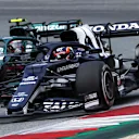 SPIELBERG, AUSTRIA - JULY 04: Yuki Tsunoda of Japan driving the (22) Scuderia AlphaTauri AT02 Honda and Sebastian Vettel of Germany driving the (5) Aston Martin AMR21 Mercedes battle for position during the F1 Grand Prix of Austria at Red Bull Ring on July 04, 2021 in Spielberg, Austria. (Photo by Clive Mason - Formula 1/Formula 1 via Getty Images)