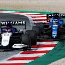 SPIELBERG, AUSTRIA - JULY 04: George Russell of Great Britain driving the (63) Williams Racing FW43B Mercedes leads Fernando Alonso of Spain driving the (14) Alpine A521 Renault during the F1 Grand Prix of Austria at Red Bull Ring on July 04, 2021 in Spielberg, Austria. (Photo by Clive Mason - Formula 1/Formula 1 via Getty Images)