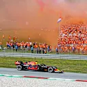 SPIELBERG, AUSTRIA - JULY 04: Race winner Max Verstappen of the Netherlands driving the (33) Red Bull Racing RB16B Honda past a grandstand full of his fans celebrating during the F1 Grand Prix of Austria at Red Bull Ring on July 04, 2021 in Spielberg, Austria. (Photo by Joe Portlock - Formula 1/Formula 1 via Getty Images)