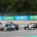 SPIELBERG, AUSTRIA - JULY 04: Fernando Alonso of Spain driving the (14) Alpine A521 Renault leads Kimi Raikkonen of Finland driving the (7) Alfa Romeo Racing C41 Ferrari during the F1 Grand Prix of Austria at Red Bull Ring on July 04, 2021 in Spielberg, Austria. (Photo by Joe Portlock - Formula 1/Formula 1 via Getty Images)